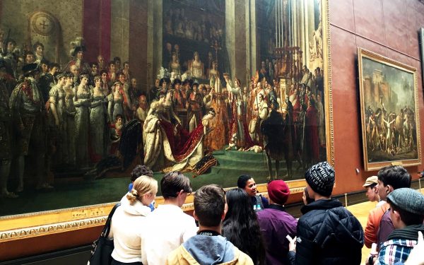 Students admiring large paintings