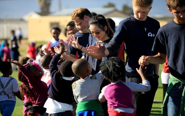 Clapping Hands Students with local students after games Service Learning Tour Cape Town South Africa