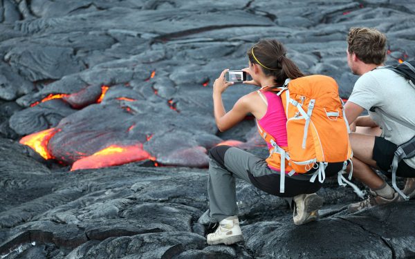 Students taking photos of small lava stream